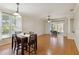 Bright dining area with wood floors, a ceiling fan, sliding glass doors, and four chairs at 5815 Pine Grove Run, Oviedo, FL 32765