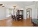 A well lit dining room featuring wood floors, a formal table, and large windows at 5815 Pine Grove Run, Oviedo, FL 32765
