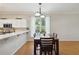 Dining room featuring dark wood table and chairs with kitchen view and window at 5815 Pine Grove Run, Oviedo, FL 32765