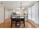 Open dining room with chandelier, view into the kitchen, and lots of natural light at 5815 Pine Grove Run, Oviedo, FL 32765