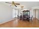 A spacious dining room featuring wood floors, a formal table, and large windows at 5815 Pine Grove Run, Oviedo, FL 32765