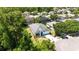 Aerial view of single Gathering home with blue accents, mature landscaping, and long driveway at 5815 Pine Grove Run, Oviedo, FL 32765