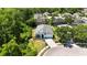 Aerial view of single Gathering home with blue accents, mature landscaping, and long driveway at 5815 Pine Grove Run, Oviedo, FL 32765