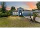 Charming single-Gathering home featuring manicured landscaping, a two-car garage, and inviting curb appeal at 5815 Pine Grove Run, Oviedo, FL 32765