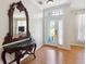Elegant foyer featuring a beautiful mirror, decorative table, and light-colored flooring at 5815 Pine Grove Run, Oviedo, FL 32765