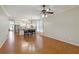 Open concept living and dining area with wood flooring and kitchen in the background at 5815 Pine Grove Run, Oviedo, FL 32765