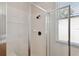 A glass-enclosed shower featuring tiled walls, a shower head and a bench at 5815 Pine Grove Run, Oviedo, FL 32765