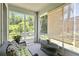 Relaxing sunroom with screen windows and wicker furniture offers a calm space with nature views at 5815 Pine Grove Run, Oviedo, FL 32765
