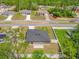 Aerial view of a home showcasing its fenced backyard, nearby houses, and surrounding trees at 601 Marion Oaks Blvd, Ocala, FL 34473