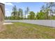 Spacious backyard featuring a long white fence and lush greenery with scattered trees at 601 Marion Oaks Blvd, Ocala, FL 34473