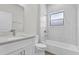 Modern bathroom showcasing marble tile, a tub-shower combo, and a vanity with stone countertops at 601 Marion Oaks Blvd, Ocala, FL 34473