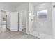 Modern bathroom with an open glass shower, neutral paint, modern fixtures, and sleek wood-look floors at 601 Marion Oaks Blvd, Ocala, FL 34473