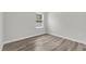 Minimalist bedroom featuring a window and wood-look flooring that adds warmth to the neutral tones at 601 Marion Oaks Blvd, Ocala, FL 34473