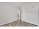 Well-lit bedroom offers ample closet space, complemented by sleek wood-look flooring and neutral decor at 601 Marion Oaks Blvd, Ocala, FL 34473