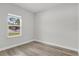 Sunny bedroom features a window that offers outdoor views, and wood-look flooring at 601 Marion Oaks Blvd, Ocala, FL 34473