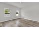 Bright and airy bedroom featuring multiple windows, neutral walls and wood-look flooring creating a serene space at 601 Marion Oaks Blvd, Ocala, FL 34473