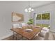 Cozy dining area features a wooden table, elegant chandelier, and sliding glass doors to the backyard at 601 Marion Oaks Blvd, Ocala, FL 34473