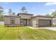 Charming single-story home with a neutral color scheme, well-manicured lawn, and a two-car garage at 601 Marion Oaks Blvd, Ocala, FL 34473
