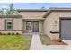 Inviting home entrance with a well-kept lawn, pathway, and complementary colors, adding curb appeal at 601 Marion Oaks Blvd, Ocala, FL 34473