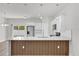 Bright open kitchen with stainless steel appliances, white cabinets, wood accents and sliding glass door at 601 Marion Oaks Blvd, Ocala, FL 34473