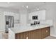 Modern kitchen features stainless steel refrigerator, stylish wood accents and white countertops at 601 Marion Oaks Blvd, Ocala, FL 34473