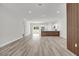 Bright, open-concept living room featuring sleek flooring and a modern accent wall, seamlessly connected to the kitchen at 601 Marion Oaks Blvd, Ocala, FL 34473