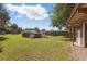 Wide backyard featuring an above-ground pool, stone patio, and shed, offering ample space for outdoor activities at 62 Magnolia Dr, Debary, FL 32713