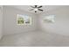 Minimalist bedroom featuring tile floors, two windows, and plenty of natural light at 62 Magnolia Dr, Debary, FL 32713