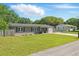 Inviting single-story home with manicured lawn, charming shutters, and a convenient driveway leading to the garage at 62 Magnolia Dr, Debary, FL 32713