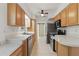 Functional kitchen featuring stainless steel appliances, wooden cabinets, and ample counter space at 62 Magnolia Dr, Debary, FL 32713