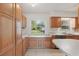 Bright kitchen featuring wood cabinets, tile flooring, and a large window view at 62 Magnolia Dr, Debary, FL 32713