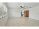 Spacious living room with tile flooring, ceiling fan, and large windows for natural light at 62 Magnolia Dr, Debary, FL 32713