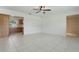 Open-concept living room featuring tile flooring, access to the kitchen, and a ceiling fan at 62 Magnolia Dr, Debary, FL 32713