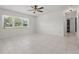 Generously sized living room featuring a ceiling fan, tile floors, and lots of natural light from multiple windows at 62 Magnolia Dr, Debary, FL 32713