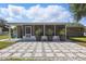 Back patio featuring stone pavers, planters, and screened-in section of the house at 62 Magnolia Dr, Debary, FL 32713