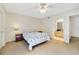Bright bedroom features neutral walls, ceiling fan, and adjacent bathroom at 725 Crest Pines Dr # 422, Orlando, FL 32828