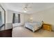 Cozy bedroom featuring soft carpet, ceiling fan, window, and a full-sized bed at 725 Crest Pines Dr # 422, Orlando, FL 32828