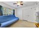 Bedroom with a futon near a large window at 725 Crest Pines Dr # 422, Orlando, FL 32828