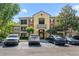 Exterior view of building with colorful painted facade and ample parking for residents and guests at 725 Crest Pines Dr # 422, Orlando, FL 32828