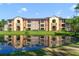 Apartment exterior reflecting beautifully in a pond at 725 Crest Pines Dr # 422, Orlando, FL 32828