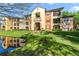 Beautiful building with well maintained landscaping, small pond, and colorful paint at 725 Crest Pines Dr # 422, Orlando, FL 32828