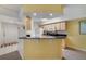 Kitchen pass-through into dining room, featuring black countertops, and stainless steel appliances at 725 Crest Pines Dr # 422, Orlando, FL 32828