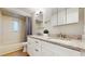 Bathroom features a double sink vanity with granite countertop and matching cabinetry at 7845 Clubhouse Estates Dr, Orlando, FL 32819