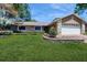 Charming single-Gathering home featuring a well-manicured front yard and attached 2-car garage at 7845 Clubhouse Estates Dr, Orlando, FL 32819