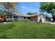 Lovely single-Gathering home with an attached garage, beautiful landscaping, and a lush green lawn at 7845 Clubhouse Estates Dr, Orlando, FL 32819
