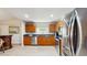 Well-lit kitchen features stainless steel appliances, wood cabinets, and sleek countertops at 7845 Clubhouse Estates Dr, Orlando, FL 32819