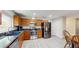 Bright kitchen features stainless steel appliances and stylish countertops and hardwood floors at 7845 Clubhouse Estates Dr, Orlando, FL 32819