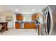 Modern kitchen with stainless steel appliances, wooden cabinetry, and granite countertops at 7845 Clubhouse Estates Dr, Orlando, FL 32819