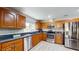 Modern kitchen boasts stainless steel appliances, granite counters, and wooden cabinets at 7845 Clubhouse Estates Dr, Orlando, FL 32819