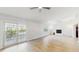 Spacious living room features sliding glass doors, hardwood floors and a fireplace feature at 7845 Clubhouse Estates Dr, Orlando, FL 32819